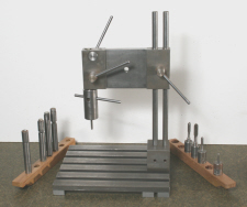 Tapping stand having controled feed to match pitch of tap being used.