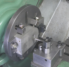 Faceplate dogs, used to position and secure the workpiece. 